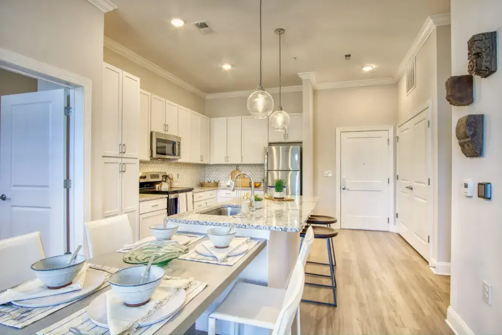 Interior View of The Retreat apartments that shows the dining room and kitchen as models.